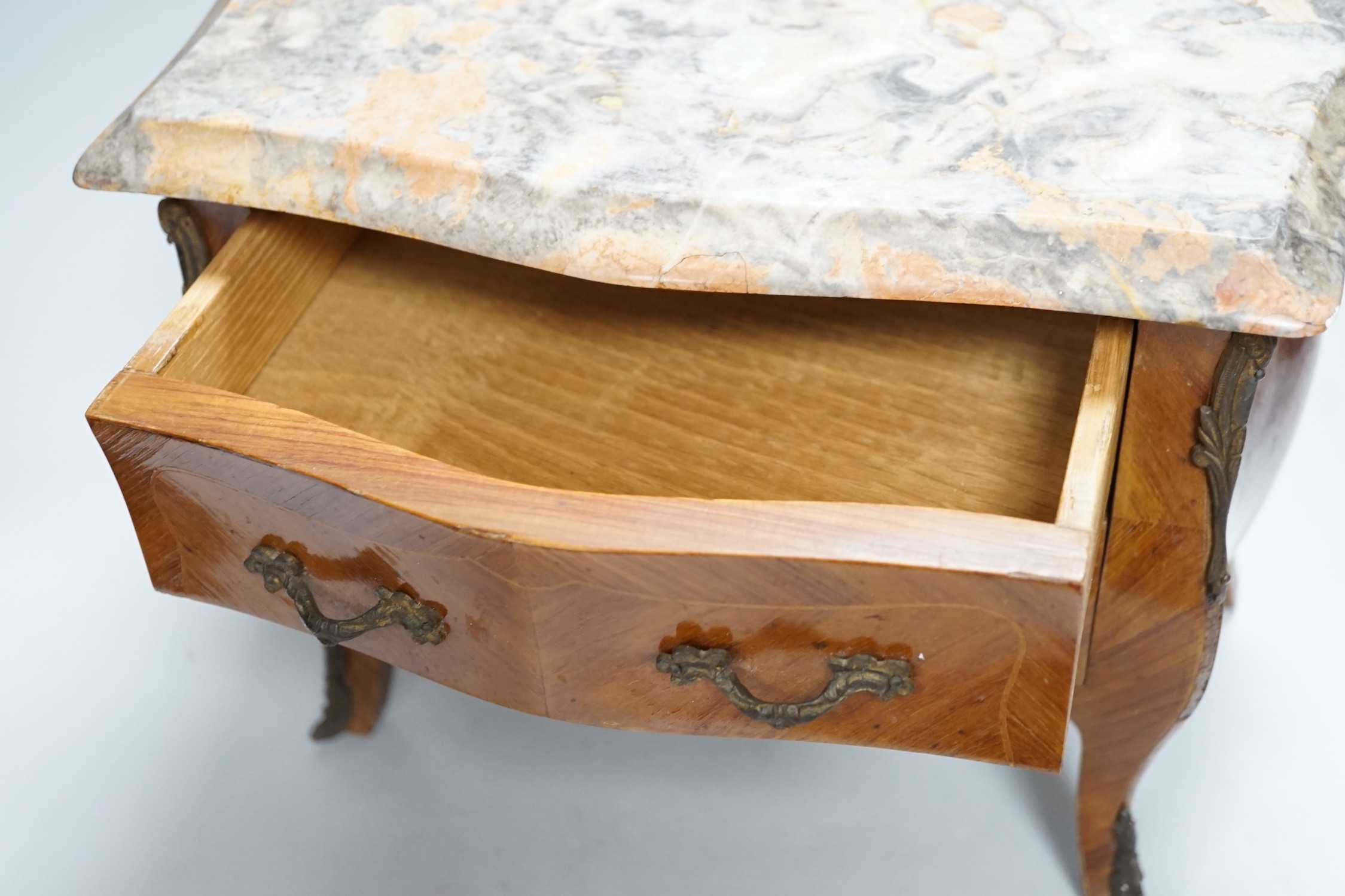 An Apprentice piece: Louis XV style miniature bowfronted French chest, with gilt mounts and pink and grey marble top. 27cm tall, 36cm wide, 17cm deep